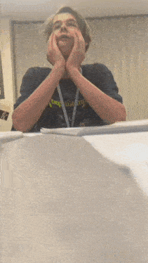 a young man wearing a black shirt that says captain on it