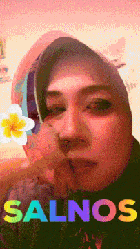 a woman wearing a hijab with the name salnos on the bottom