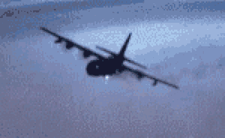 a fighter jet is flying through the air with smoke coming out of its engines .