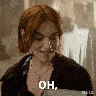 a woman with red hair and a necklace says " oh " in white letters