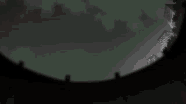 a shadow of a person is cast on a wall in a dark room