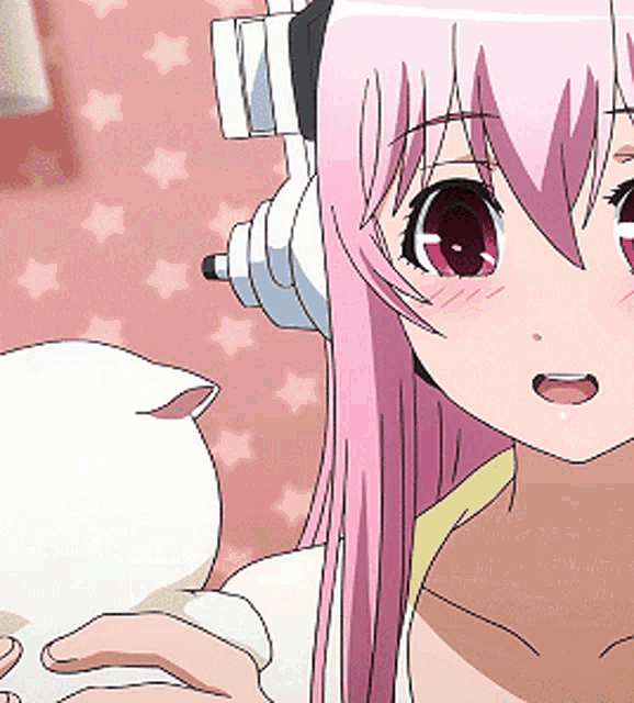 a girl with pink hair is wearing headphones