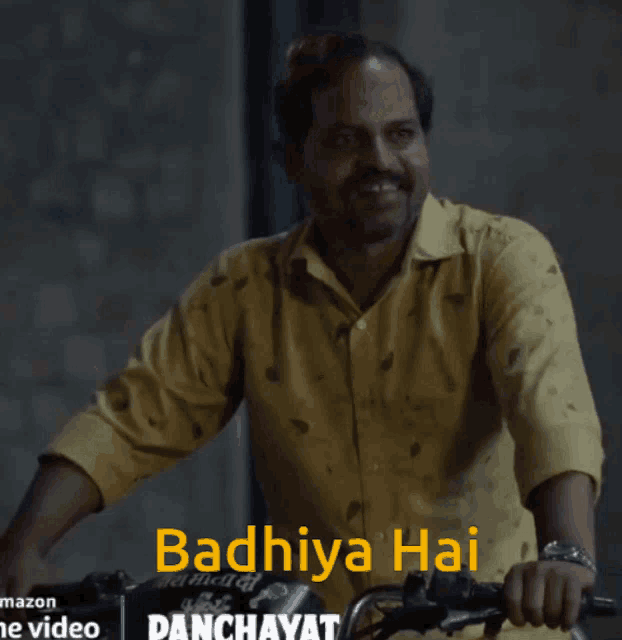 a man in a yellow shirt is smiling while riding a motorcycle