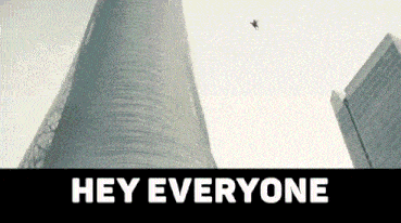 a plane is flying over a city with the words hey everyone written below it