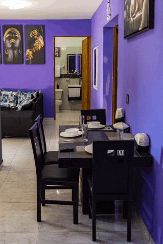 a room with purple walls and a dining table