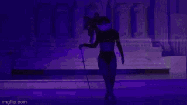 a woman in lingerie is holding a sword in front of a purple building .