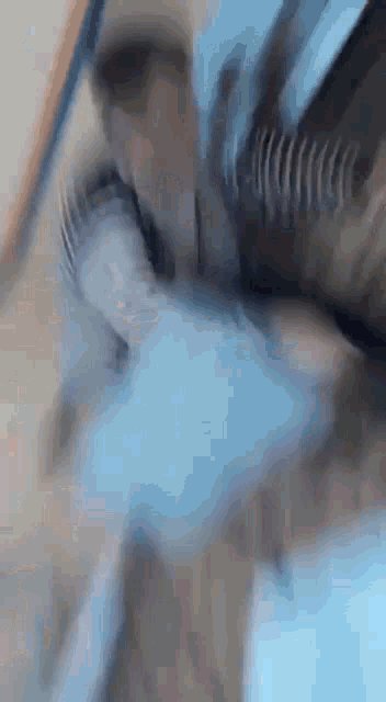 a blurry picture of a person 's face with a blue glove on .