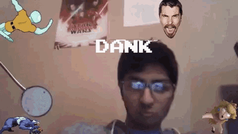 a man wearing glasses stands in front of a wall with a poster of star wars hanging on it
