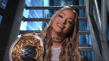 a woman is holding a wrestling championship belt with the w logo on it