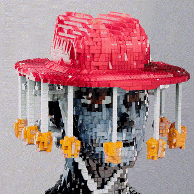 a statue of a man wearing a red hat with a ferris wheel attached to it