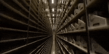 a very long narrow hallway with rows of shelves with numbers 1 through 12 on them