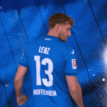 a man in a blue jersey with the number 13 on the back