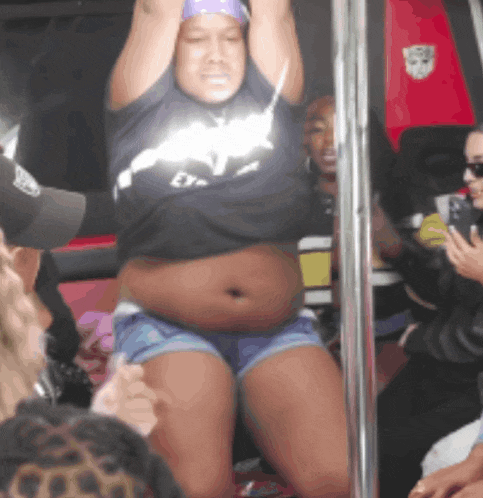 a woman wearing a black shirt that says ' ey ' on it