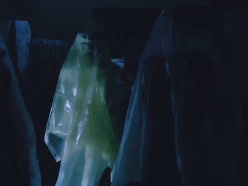 a ghostly figure is hanging from a clothesline in a dark room