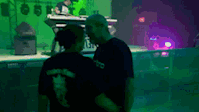 a man and a woman are standing in front of a keyboard with the word yamaha on the back