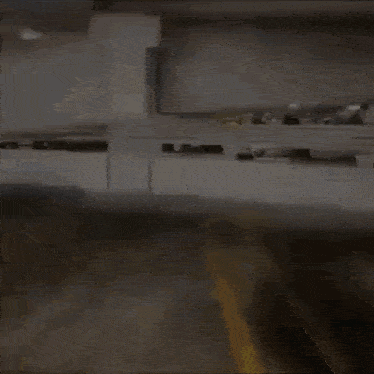a person is walking in a parking garage with a yellow line on the ground