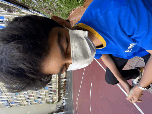 a young man wearing a blue shirt that says ema