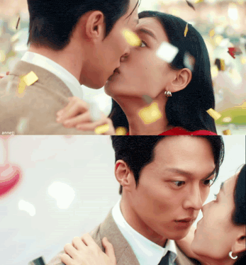 a man and a woman are kissing in front of confetti flying around them