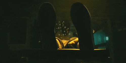a close up of a person 's fist with a yellow light behind it