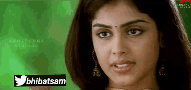 a close up of a woman 's face with a twitter logo in front of her
