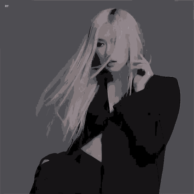 a woman with long blonde hair is wearing a black jacket and a black top