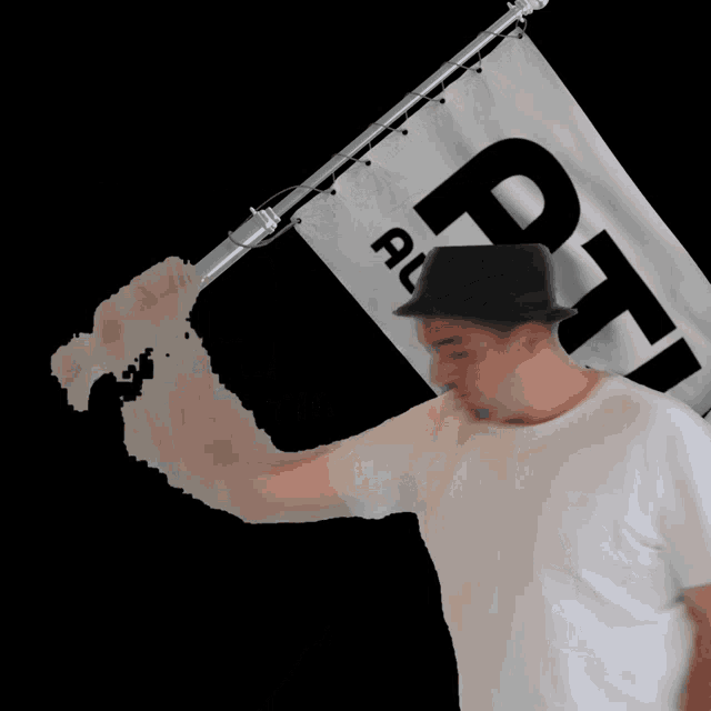 a blurry picture of a man holding a flag with the word ptf on it