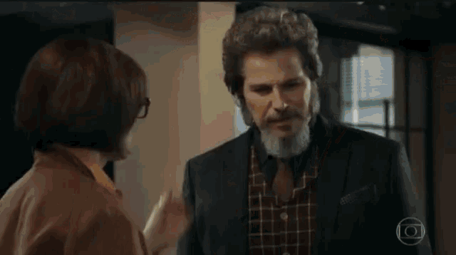 a woman touches a man 's nose in a scene from a show