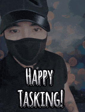 a man wearing a mask and a hat with the words happy tasking