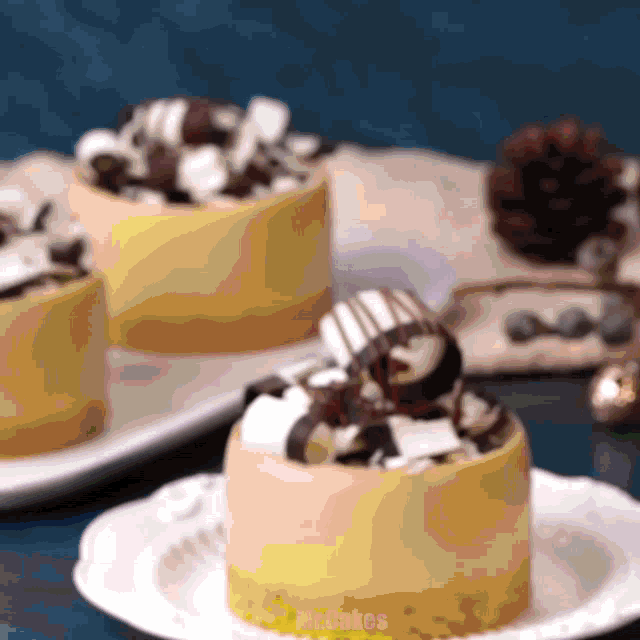 three desserts on a white plate with mr.cakes written on it