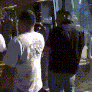 a man in a white t-shirt with the number 88 on the back is standing next to another man