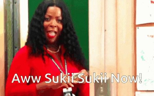 a woman in a red shirt with the words aww sukii sukii now written on the bottom