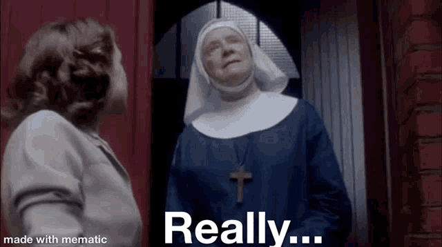 a nun is standing next to a woman in a doorway and talking to her .
