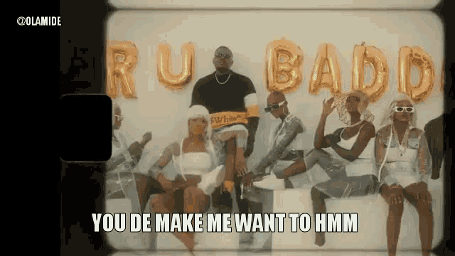 a group of people are sitting in front of balloons that say rubado .