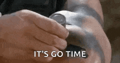 a person is holding a watch in their hand and the words `` it 's go time '' are visible .