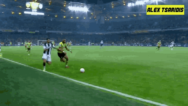 a soccer game is being played in a stadium with alex tsaridis in the corner