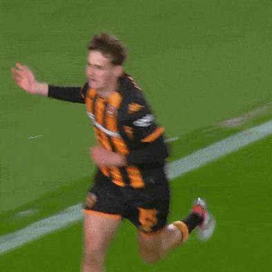 a soccer player wearing a black and orange striped jersey with the word kappa on the sleeve