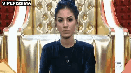 a woman is sitting in a chair with the words viperissima on the bottom