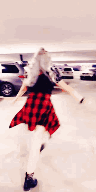 a blurred image of a person rollerblading in a parking garage