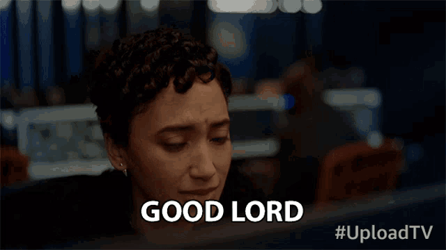a woman sitting in front of a computer with the words good lord written on the screen