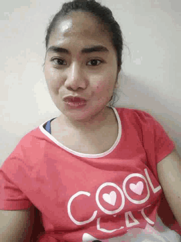 a woman wearing a red shirt that says cool