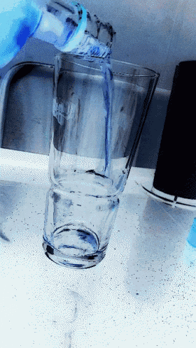 a bottle of vodka is poured into a glass