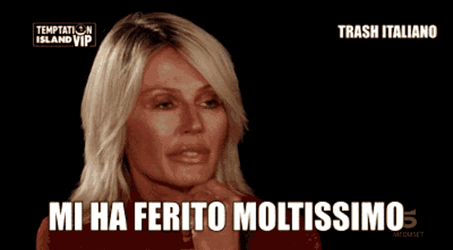 a woman says mi ha ferito moltissimo in front of a black background