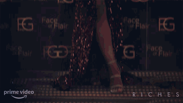 a woman in a red dress is standing in front of a wall with face of flair written on it