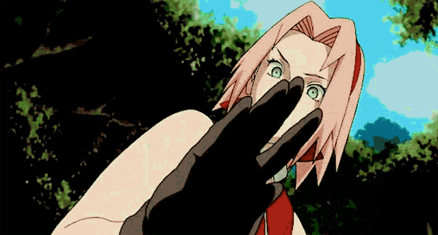a woman with pink hair is covering her mouth with her hand .