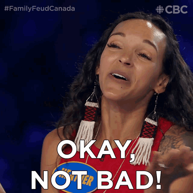 a woman says okay not bad in front of a blue sign that says family feud canada