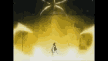 a person is standing in a dark room with a lot of yellow smoke coming out of the ceiling .