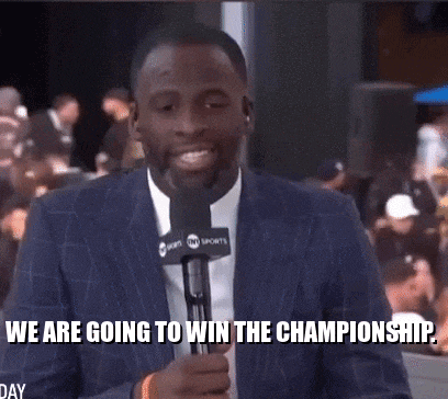 a man in a suit is holding a microphone and saying " we are going to win the championship "