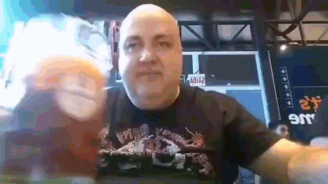 a bald man wearing a black shirt that says heavy metal on it