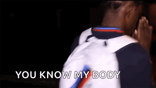 a man with a backpack is saying `` you know my body '' while standing in a dark room .