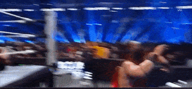 a blurry picture of a wrestling ring with the letters wwe on the bottom right